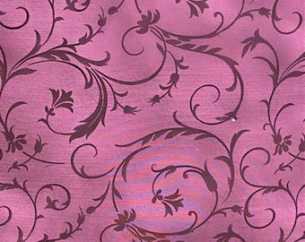 May include: Close-up of a pink fabric with a dark brown floral pattern. The design features swirling vines, leaves, and stylized flower shapes. The fabric has a subtle texture and a gradient of pink hues.