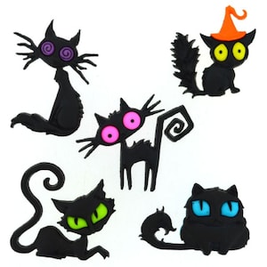 May include: A collection of black cat-shaped embellishments with various eye colors, including purple, pink, green, yellow, and blue. One cat wears an orange witch hat. The cats have exaggerated features and are in different poses.