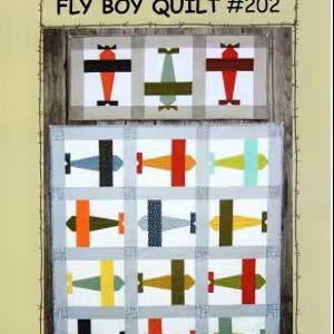 May include: A quilt pattern titled "Fly Boy Quilt #202" by Suzanne's Art House. The quilt features a repeating pattern of colorful airplanes in various colors, including red, orange, green, and blue, set against a white background. The quilt is framed by a light blue border.