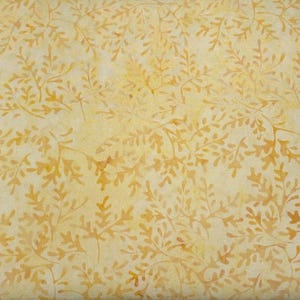 May include: A fabric with a repeating pattern of golden-brown leaf-like shapes on a light yellow background. The design has a watercolor effect, with variations in color and texture. The overall look is soft and natural.