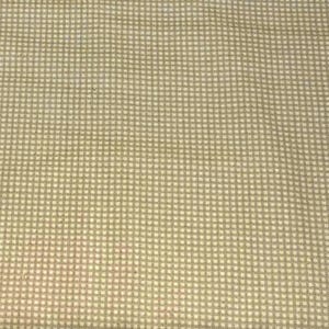 May include: Close-up of a fabric with a small, repeating checkered pattern. The pattern is a light beige color with a slightly darker beige grid. The fabric has a slightly textured appearance.