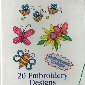 May include: A CD-ROM with 20 embroidery designs featuring butterflies, bees, and flowers. The designs are for a 100mm x 100mm hoop. The CD-ROM is labeled "Flutterby Friends" and "Multi-Format CD-ROM". The disk part number is 556 257200. The CD-ROM is from the inspira brand.