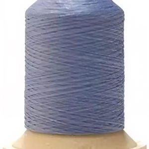 May include: A spool of light blue thread, tightly wound around a cream-colored base. The thread is a solid color, and the spool has a cylindrical shape with a slightly tapered top. Ideal for sewing and crafting projects.