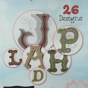 May include: A package of 26 embroidery designs featuring a variety of stylized letters in different colors. The package is titled "Font-Tastic" by Michael Miller Fabrics and includes the text "Artistic Go ahead. Be an Artist."