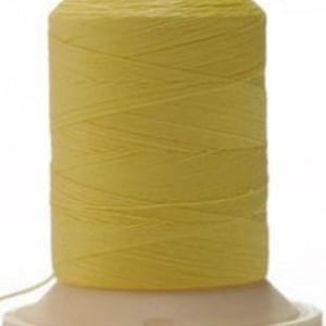 May include: A spool of yellow thread on a white plastic bobbin.