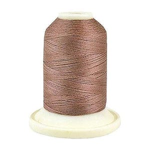 May include: A spool of brown thread on a white bobbin.