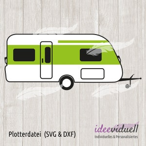 May include: A white camper with a green stripe and black windows. The camper has a door on the side and a hitch on the back. Plotterdatei (SVG & DXF) is written below the camper.