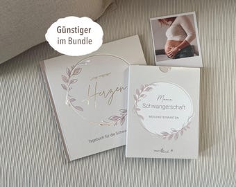 May include: Two pregnancy journals with floral designs. The first journal is titled "Our little heart" and the second journal is titled "Mama Schwangerschaft Meilensteinkarten".