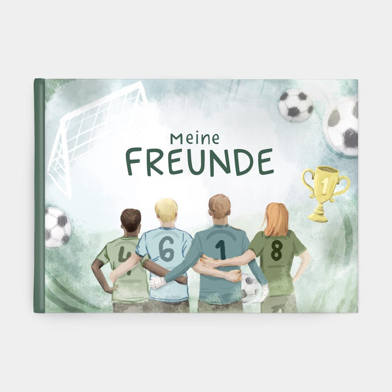 May include: A green and blue photo album with the text "Meine FREUNDE" on the cover. The cover features a watercolour illustration of four friends wearing football jerseys with numbers on the back, standing in a line with their arms around each other. There are footballs and a football goal in the background.