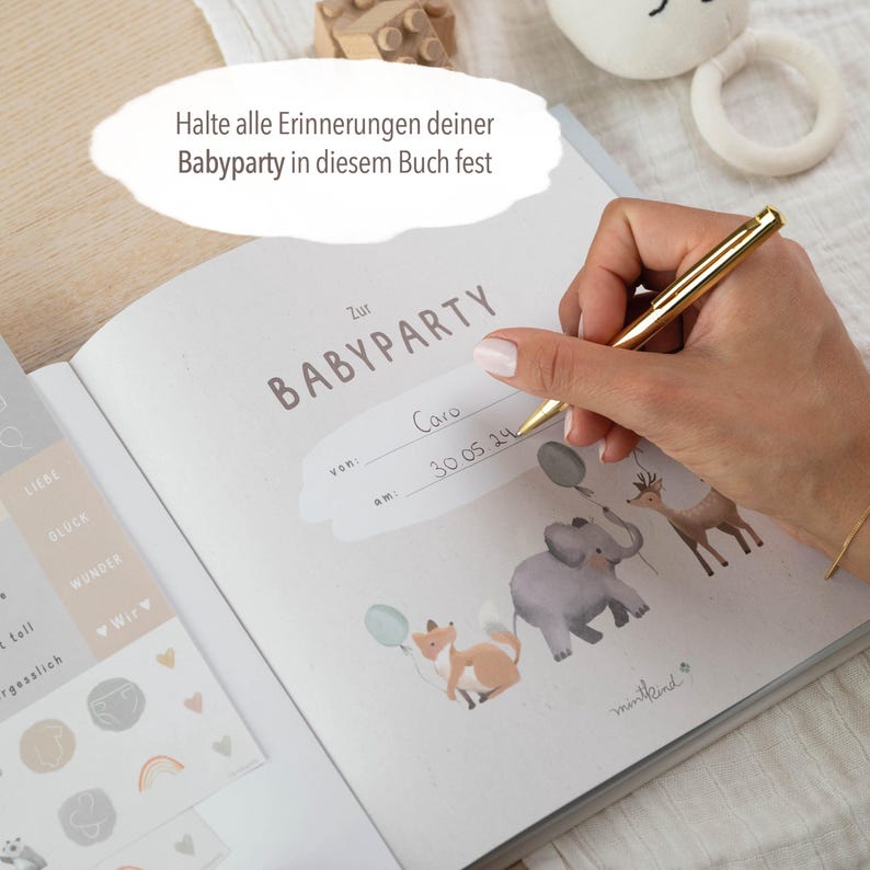 May include: A white baby shower guest book with a brown border and the text "Zur Babyparty" in brown lettering. The book has a section for the date and name of the party. The book is open to a page with a sticker that says "von" and "am" and a space to write in the date and time of the party. The book is decorated with a sticker of a fox, elephant, and deer with balloons.
