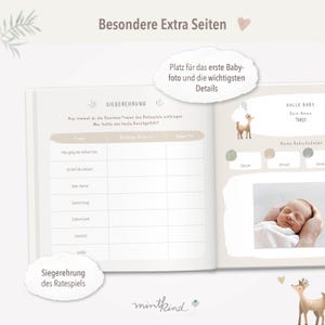 May include: A baby book with a light brown cover and a deer illustration. The book has a section for a baby's first photo and details about their birth. The text on the cover reads "Besondere Extra Seiten" and "Hallo Baby".