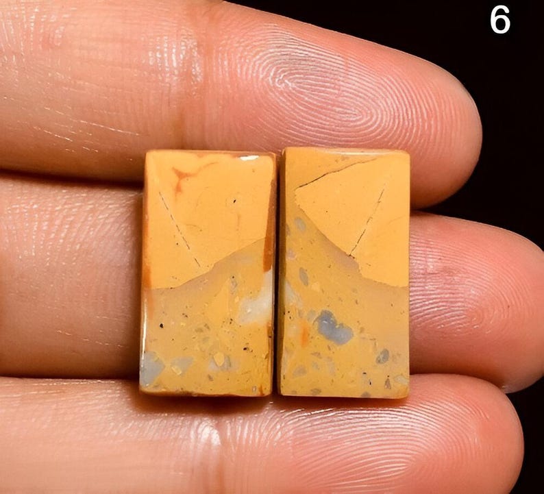 May include: Two rectangular pieces of yellow, brown, and white patterned stone. The stones have a rough, natural texture.