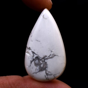May include: White Howlite cabochon with gray veining in a teardrop shape.