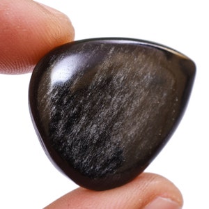 May include: A black obsidian heart-shaped stone with a smooth, polished surface. The stone has a subtle shimmer and is a popular choice for crystal healing.