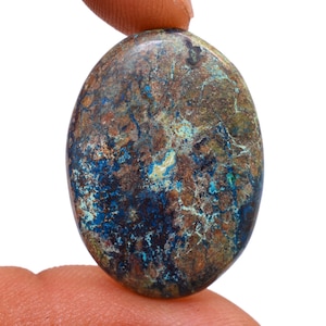May include: A blue, green, and brown oval-shaped gemstone with a marbled pattern.