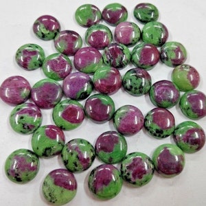 May include: A collection of 30 round, green and pink gemstone cabochons. The cabochons are smooth and polished, with a variety of patterns and colours.
