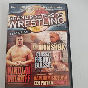 May include: DVD case for "Grand Masters of Wrestling" featuring Nikolai Volkoff, The Iron Sheik, and "Classy" Freddy Blassie. The cover includes text such as "Over 1 HOUR of great matches and exclusive behind-the-scenes interviews!"