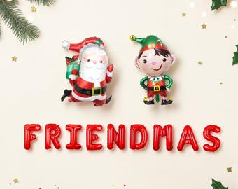 May include: Two foil balloons shaped like Santa Claus and a Christmas elf, positioned above red letter balloons that spell out the word FRIENDMAS. The Santa balloon is red and white, while the elf balloon is green and red.