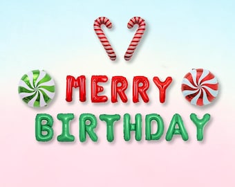 May include: A set of foil balloons spelling out MERRY BIRTHDAY in red and green letters, accompanied by two candy cane shaped balloons and two round peppermint swirl balloons in red, white, and green colours for party decoration.