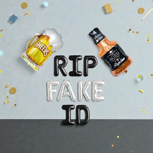May include: A festive arrangement of foil balloons spelling "RIP FAKE ID" with a beer mug and whiskey bottle. The beer mug says "Cheers" and the whiskey bottle says "Happy Birthday Aged Perfection". Confetti and decorations are scattered around.