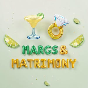 May include: A festive arrangement of inflatable balloons spelling out "MARGS & MATRIMONY." The scene includes a margarita glass, a diamond ring, and lime wedges. The balloons are in shades of green and gold, set against a light green background.