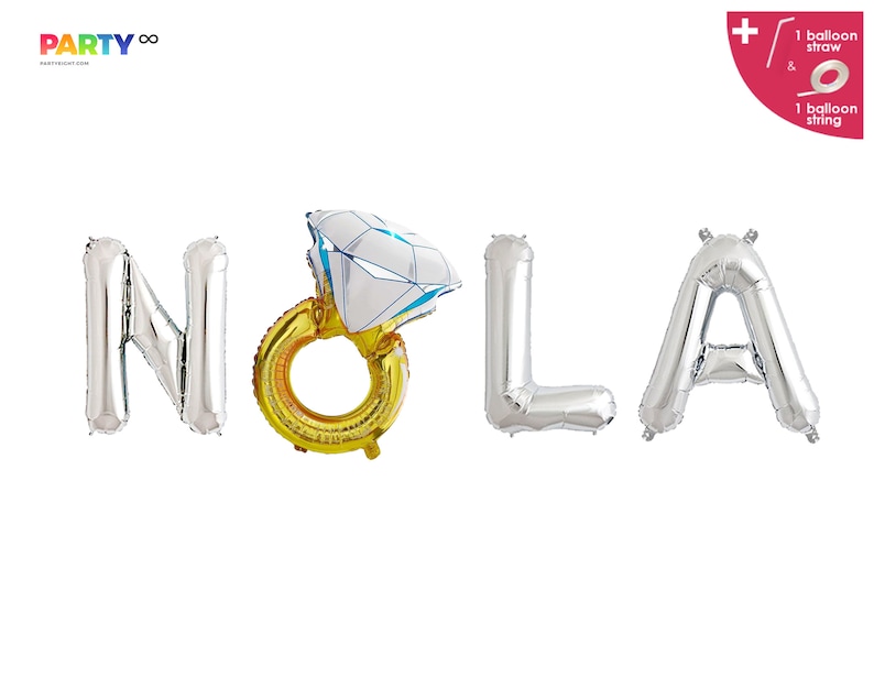 May include: Silver foil balloons spelling out "NOLA" with a gold ring balloon featuring a diamond-shaped top. The balloons are for a party or celebration. The image also includes a balloon straw and string.