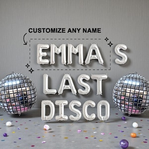 May include: Silver foil letter balloons spelling "EMMA'S LAST DISCO" with two disco ball balloons. The text "CUSTOMIZE ANY NAME" is above the name. Confetti and small decorative balls are scattered on the floor.