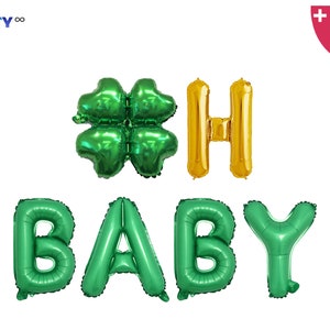 May include: Green and gold foil balloons spelling out "BABY" and "#SH" with a four-leaf clover. The balloons are for a baby shower or gender reveal party. Includes a balloon straw and string.