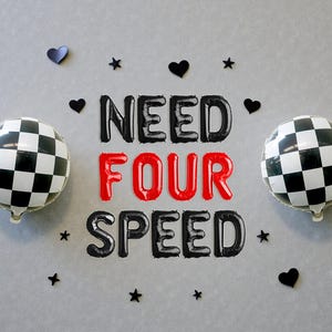 May include: Two round black and white checkered balloons flank the phrase "NEED FOUR SPEED" spelled out in black and red foil balloons. Black heart and star decorations are scattered around the balloons and text.