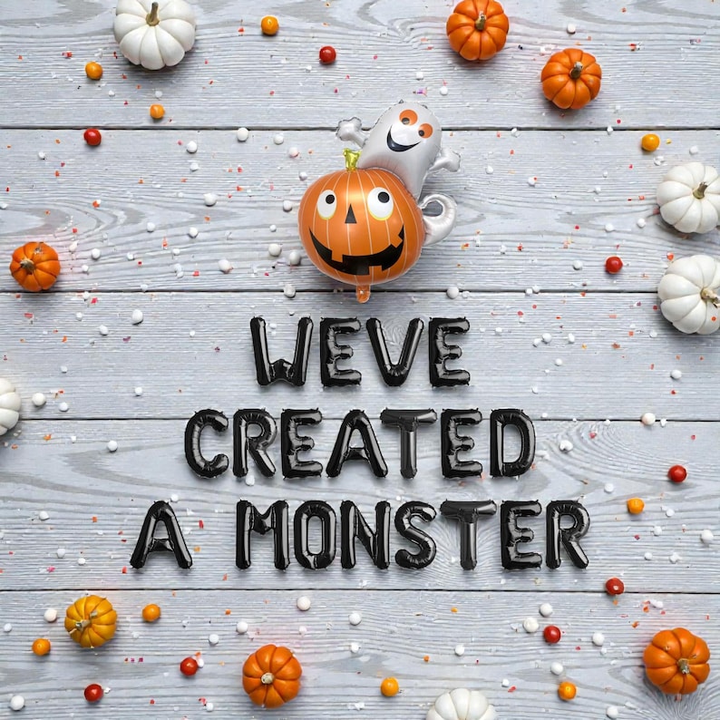 May include: A Halloween image featuring a pumpkin and ghost balloon, alongside small pumpkins and decorations. The phrase "WEVE CREATED A MONSTER" is spelled out in black balloon letters on a grey wooden background.