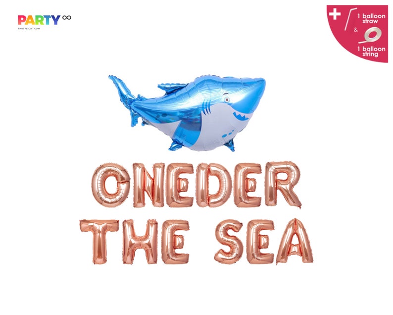May include: A blue and white shark-shaped balloon above rose gold foil letter balloons spelling "ONE DER THE SEA". The balloons are for a party. Includes a balloon straw and string.