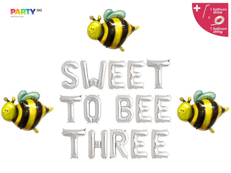 May include: A set of silver foil balloons spelling "SWEET TO BEE THREE" with three yellow and black bee-shaped balloons. The balloons are for a birthday party.