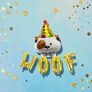 May include: A dog-shaped foil balloon wearing a party hat with the text "Happy Birthday". Below the balloon, gold foil balloons spell out "WOOF". The background is light blue with paw prints and confetti.