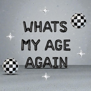 May include: Black balloon letters spell "WHATS MY AGE AGAIN" against a gray background. Two checkered black and white ball-shaped balloons and four silver star-shaped decorations are also present. The overall theme is a birthday celebration.