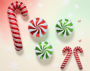 May include: A collection of foil balloons featuring one large red and white striped candy cane, two smaller round peppermint candies in red and white and green and white, and two small red and white striped candy canes against a gradient background.