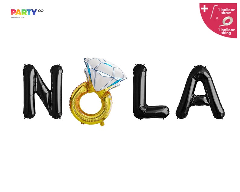 May include: Black foil balloons spelling "NOLA" with a gold ring balloon featuring a large diamond. The balloons are for a party. The image also includes a balloon straw and string.