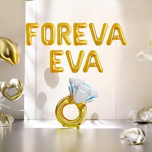 May include: Gold foil balloons spelling "FOREVER EVA" and a large ring balloon with a diamond-shaped gem. Other gold heart and round balloons are also present, creating a celebratory atmosphere.