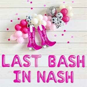 May include: A festive arrangement featuring pink balloons, a disco ball, and cow-print balloons. Two bright pink cowboy boot-shaped balloons are centered, with the text "LAST BASH IN NASH" in pink balloon letters below.