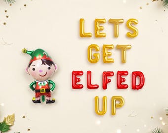 May include: A foil balloon shaped like a cartoon elf with a green hat and red outfit, positioned next to gold and red foil letter balloons that spell out the phrase LETS GET ELFED UP, arranged in three rows against a light cream background.
