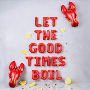 May include: Red foil balloon letters spell "LET THE GOOD TIMES BOIL" with two red lobster balloons and lemon slices. Party decorations for a seafood boil or summer celebration.