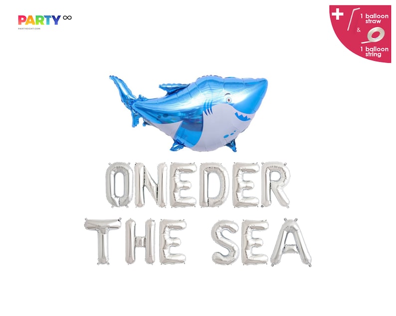 May include: A blue and white shark-shaped balloon floats above silver foil letter balloons spelling "ONEDER THE SEA." The image includes a balloon straw and string, perfect for a first birthday party with a nautical theme.