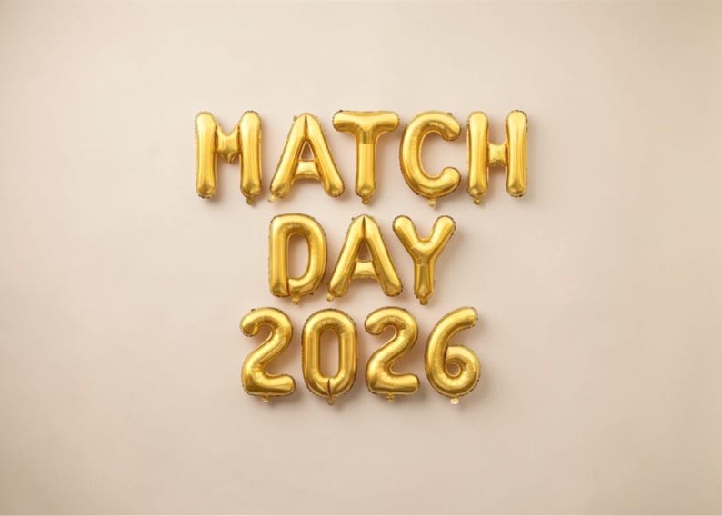 May include: Gold foil balloon letters spelling "MATCH DAY 2026" against a neutral background. The balloons are inflated and arranged to form the words and numbers, ideal for a celebratory event.