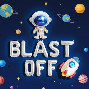 May include: A space-themed party decoration set against a dark blue background. It features a silver "BLAST OFF" balloon banner, an astronaut balloon, and a rocket ship balloon. Planets and stars are scattered throughout the design.