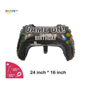May include: Black and silver foil balloon shaped like a video game controller. The balloon reads "GAME ON! It's your birthday." and measures 24 inches by 16 inches.