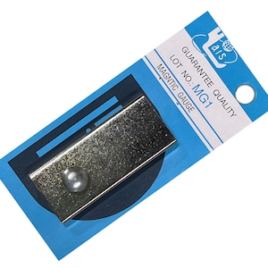 May include: A silver magnetic gauge with a round knob on a blue and white packaging card. The card says "Guarantee Quality" and "Lot No.: MG1".