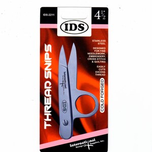 May include: A 4 1/2 inch stainless steel thread snip with a ring handle. The packaging is red and white with the text "THREAD SNIPS" and "IDS" on it. The product is designed for fine needlework, embroidery, cross stitch, and quilting.
