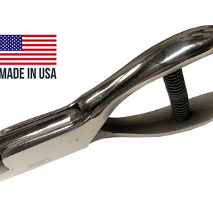 May include: A silver metal hand punch tool with a spring mechanism. The tool is made in the USA.