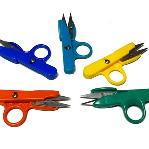 May include: Four pairs of small, colorful thread scissors with finger rings. The scissors are blue, yellow, orange, and green.