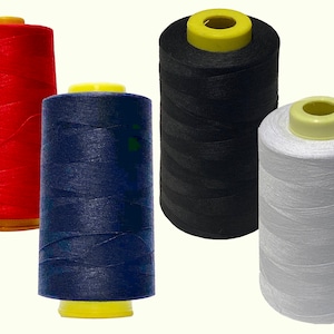 May include: Four spools of thread in red, navy blue, black, and white. The spools are all the same size and have yellow plastic tops.
