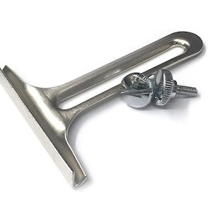 May include: A silver metal sewing machine foot with a slot for a needle and two silver screws.